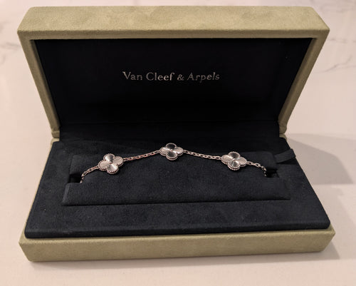 Pre-owned Van Cleef & Arpels Vintage Alhambra 5-motif bracelet in 18K white gold with guilloché finish, resting in its original green velvet presentation box.
