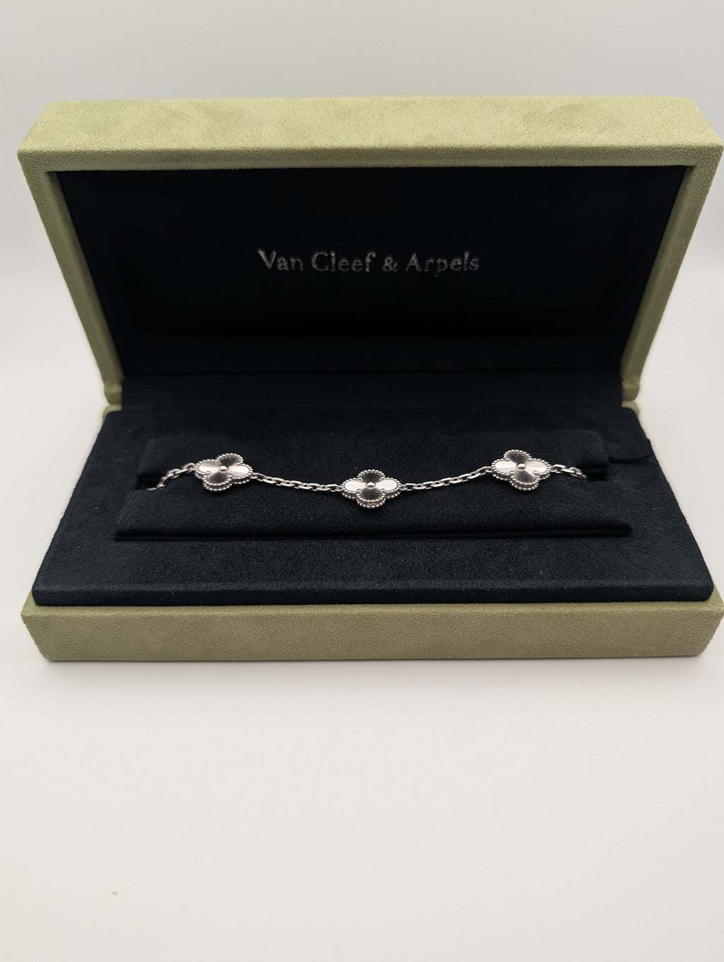 Van Cleef & Arpels bracelet in a display box on a white background