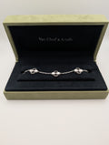 Van Cleef & Arpels bracelet in a display box on a white background