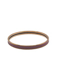 Gold and purple bangle on a light gray background