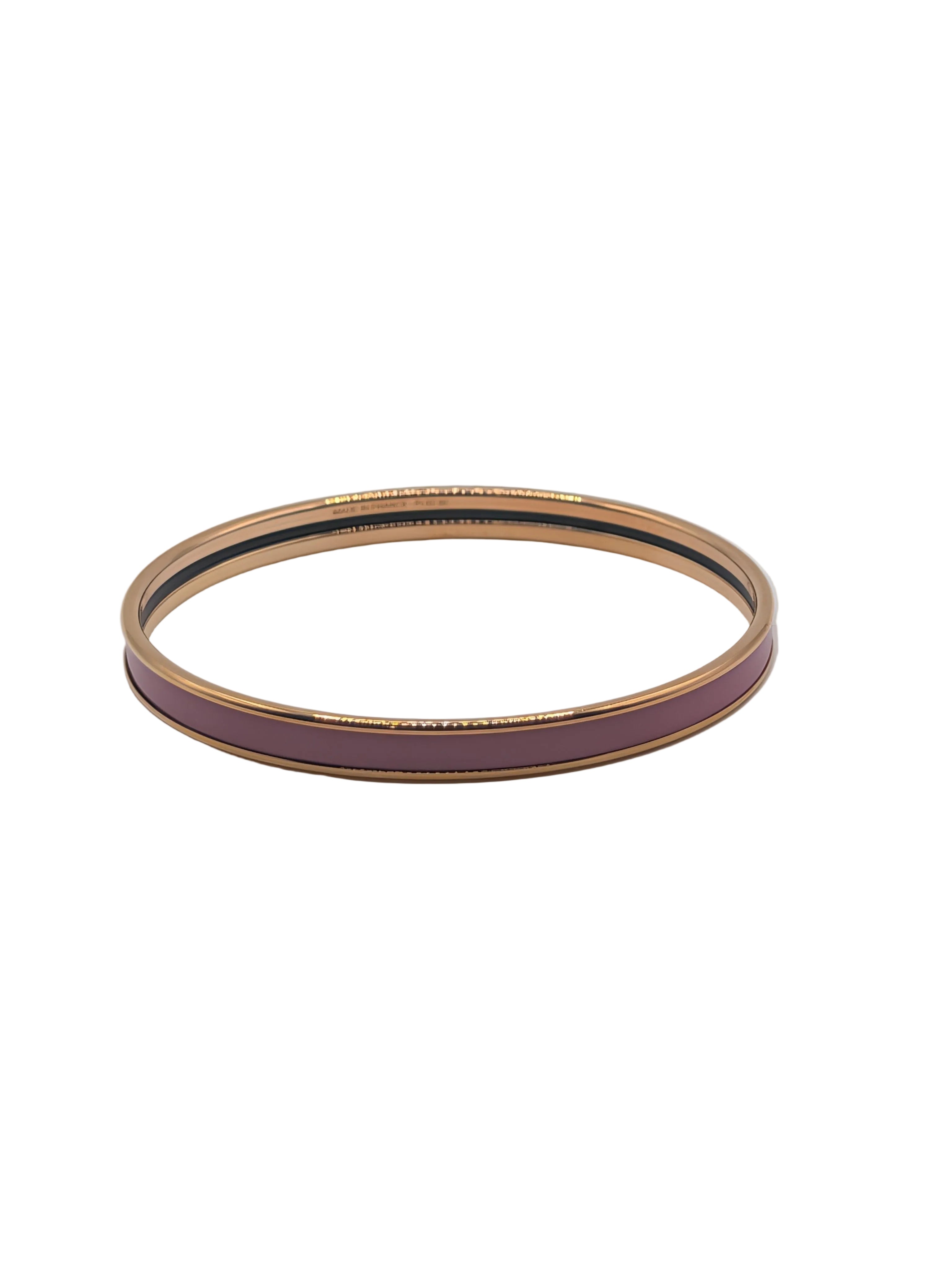 Gold and purple bangle on a light gray background